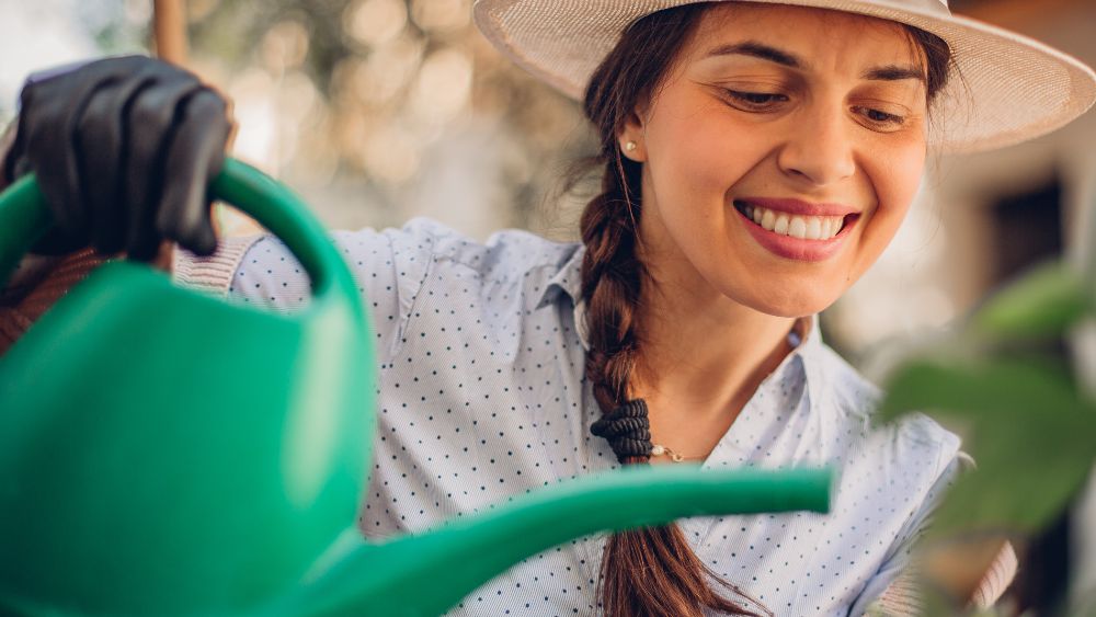Woman watering lemons
